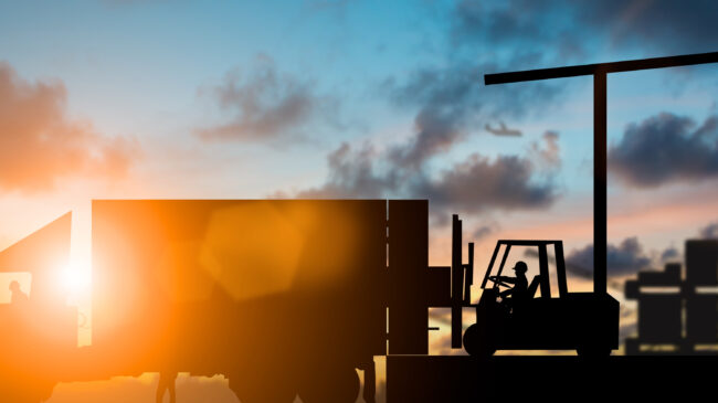 Truck and forklift at sunset